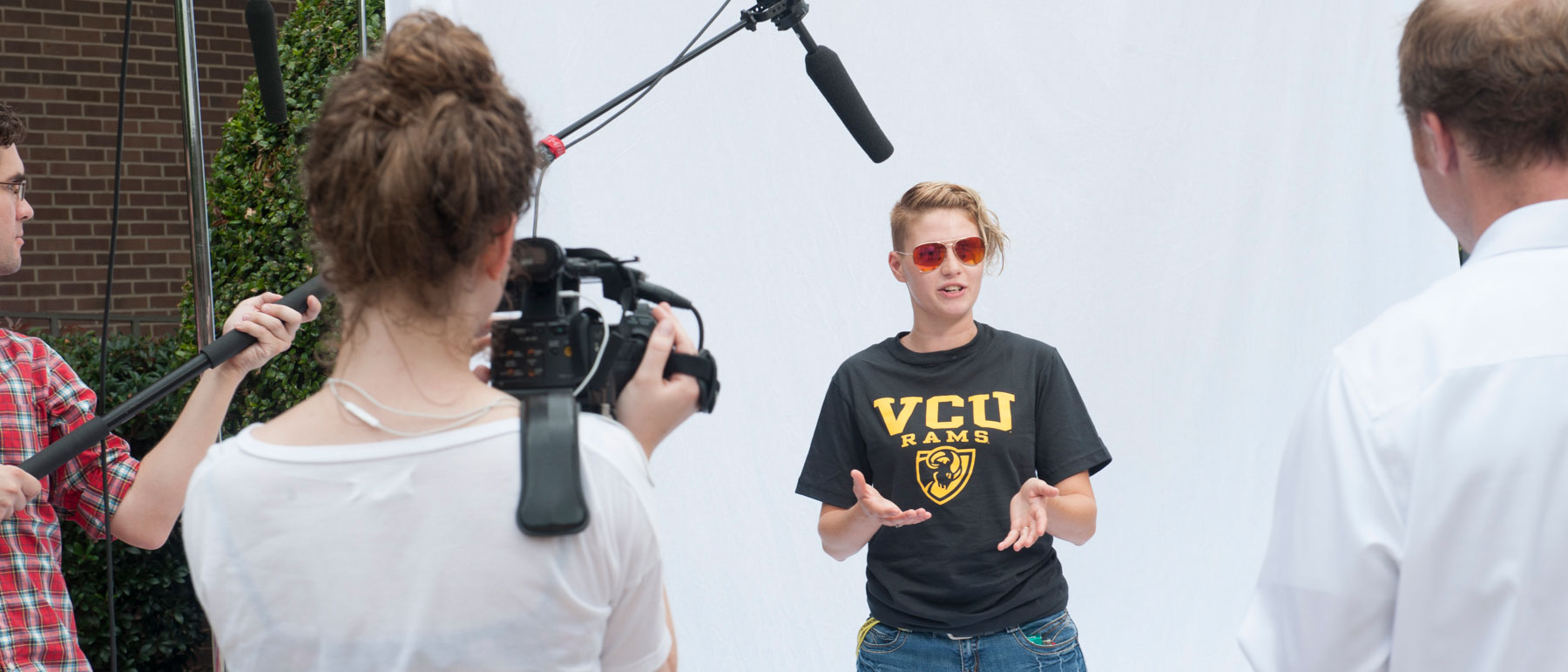a t.v. crew filming an interview with a v.c.u. student