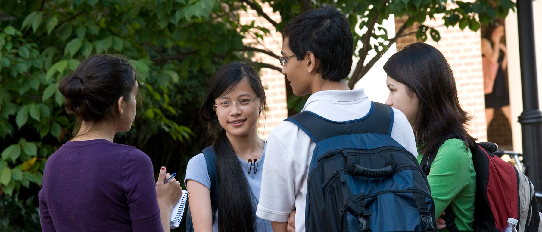 A student journalist interviewing a group of students.