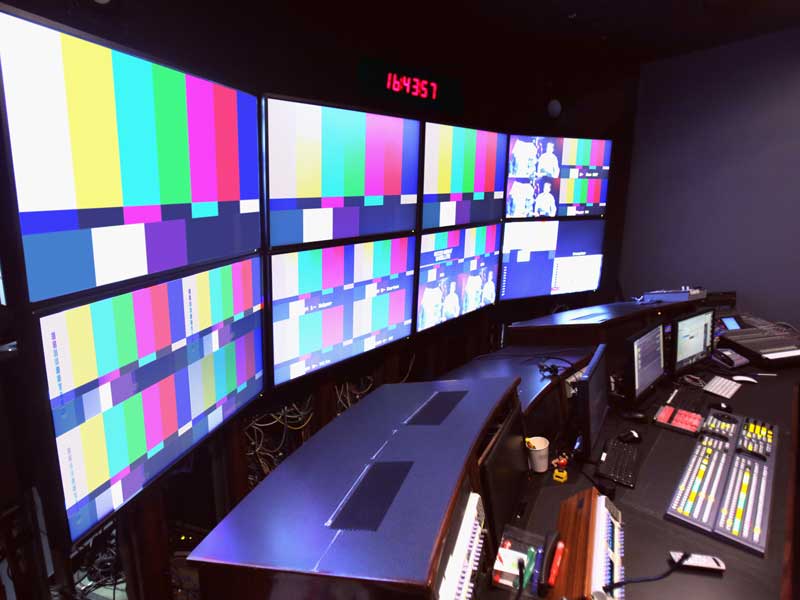 television production room with multiple t.v. screens and equipment